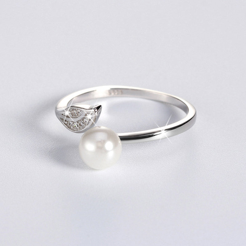 Elegant sterling silver open band ring with a single round pearl and pavé crystal detailing – modern pearl jewellery UK, minimalist pearl ring