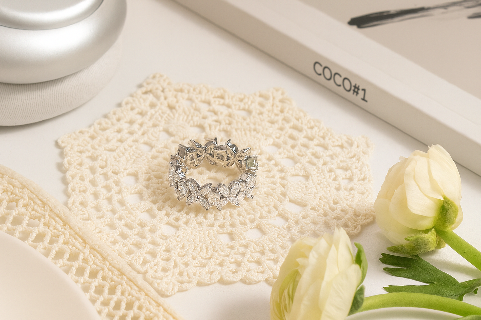 Elegant sterling silver cluster ring displayed on a lace mat with Vogue magazine and flowers – light luxury jewellery photography