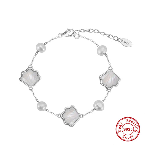Elegant sterling silver bracelet with mother-of-pearl shell charms and freshwater pearls